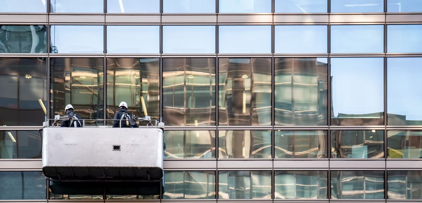Commercial window cleaning team on lift